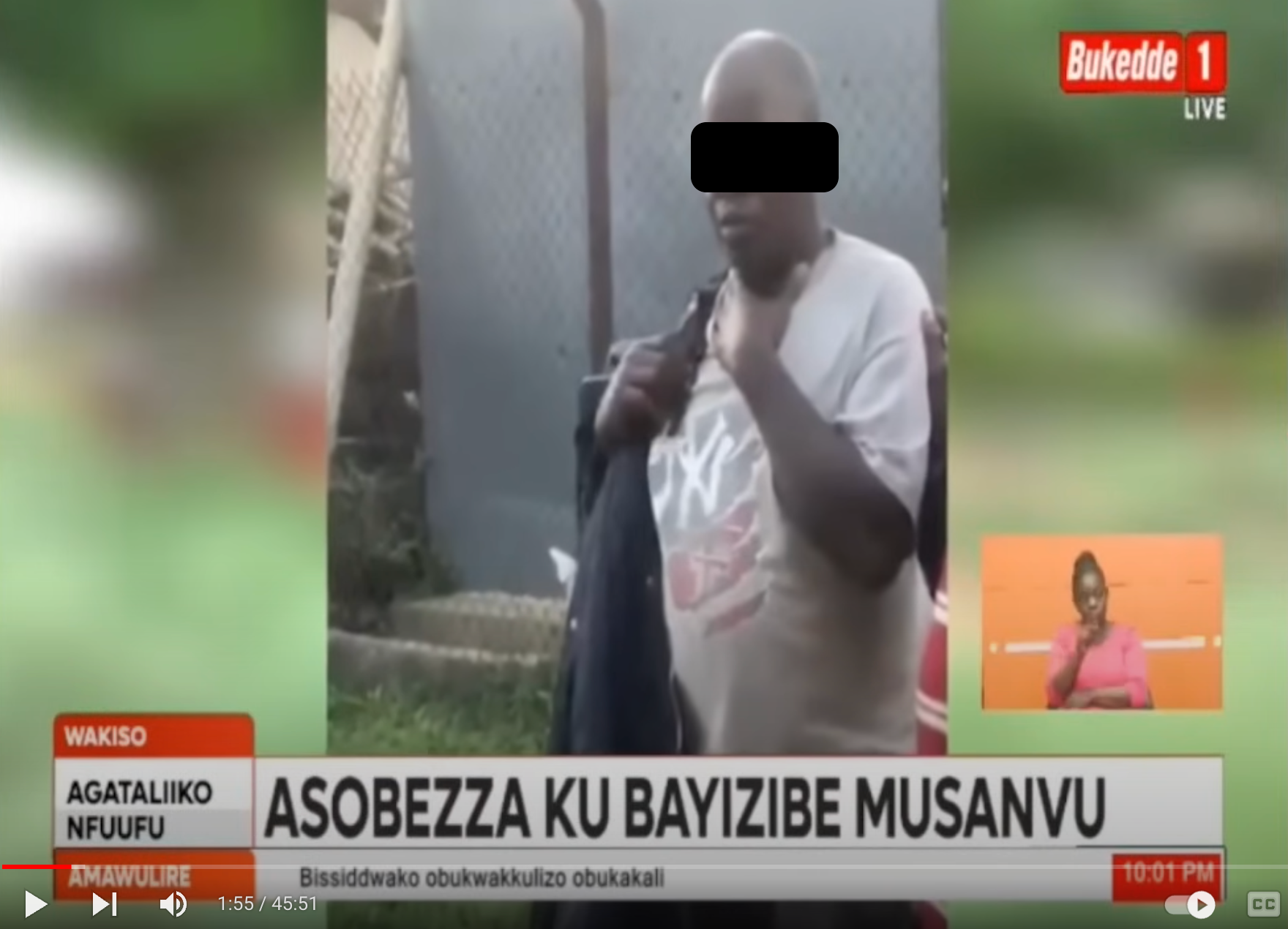 A screen shot of a Bukedde TV story showing a man (with face blacked out) being arrested at a primary school in Uganda.