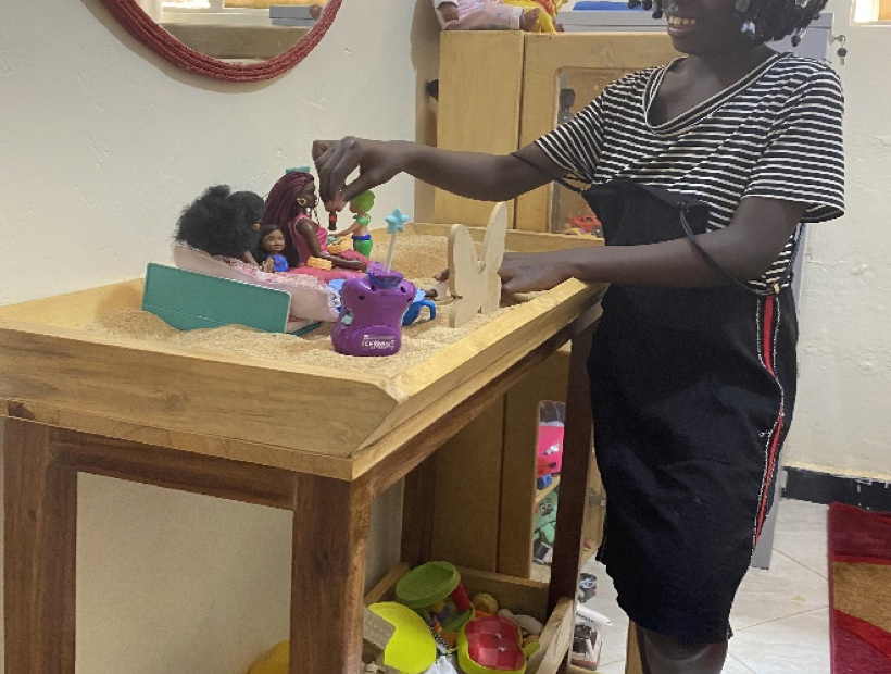 Child doing sand try therapy